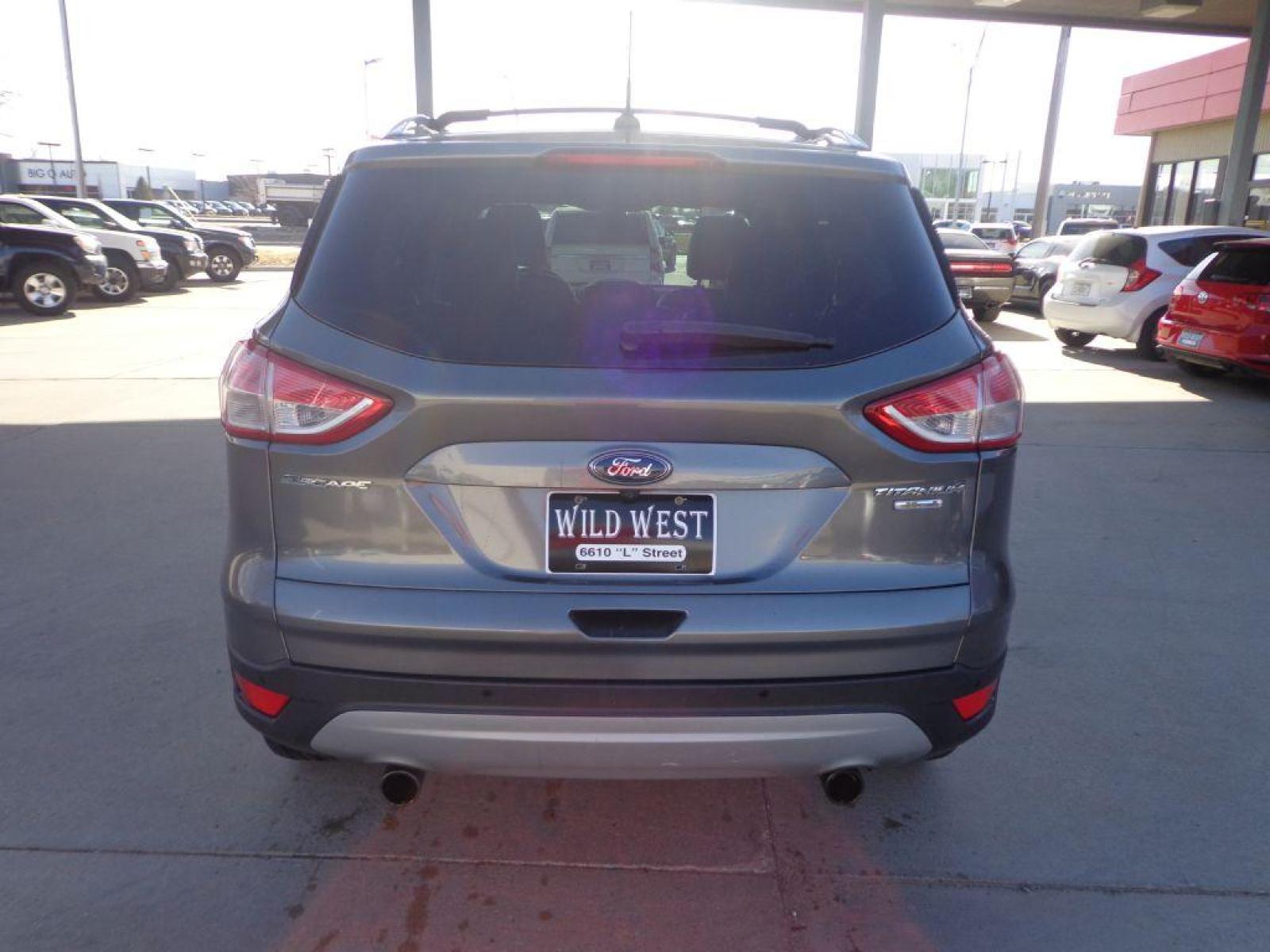 2013 GRAY FORD ESCAPE TITANIUM (1FMCU9J91DU) with an 2.0L engine, Automatic transmission, located at 6610 L St., Omaha, NE, 68117, (402) 731-7800, 41.212872, -96.014702 - 1-OWNER CLEAN CARFAX LOW MILEAGE LOADED WITH PANORAMIC ROOF, BLIND SPOT ASSIST, ACTIVE PARK ASSIST, NAV, BACKUP CAM AND MUCH MORE! *****We have found that most customers do the majority of their shopping online before visiting a dealership. For this reason we feel it necessary to have a compet - Photo #4