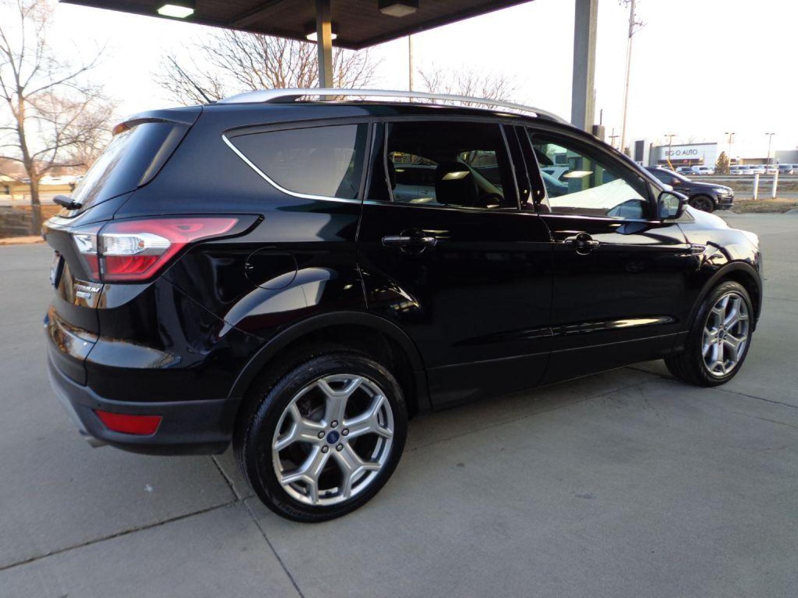 2017 BLACK FORD ESCAPE TITANIUM (1FMCU9J99HU) with an 2.0L engine, Automatic transmission, located at 6610 L St., Omaha, NE, 68117, (402) 731-7800, 41.212872, -96.014702 - SHARP 1-OWNER CLEAN CARFAX LOW MILEAGE LOADED WITH NAV, PANORAMIC ROOF, NEWER TIRES AND MUCH MORE! *****We have found that most customers do the majority of their shopping online before visiting a dealership. For this reason we feel it necessary to have a competitive price on our used vehicles - Photo #3