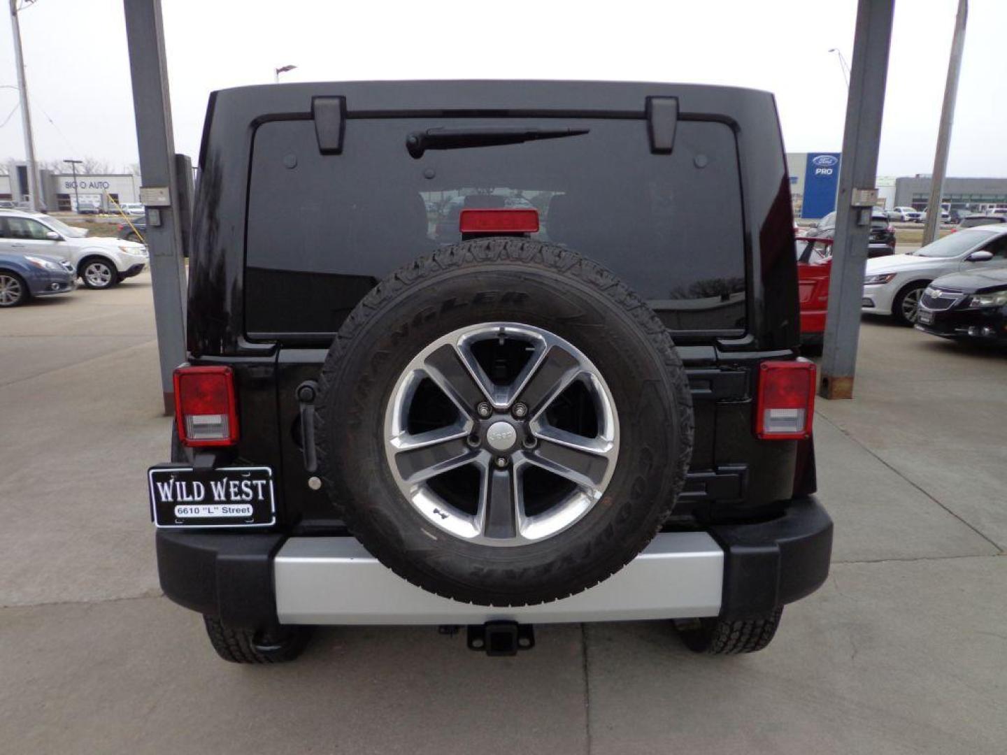 2013 BLACK JEEP WRANGLER UNLIMI SAHARA (1C4HJWEGXDL) with an 3.6L engine, Automatic transmission, located at 6610 L St., Omaha, NE, 68117, (402) 731-7800, 41.212872, -96.014702 - THIS VEHICLE HAS A BEEN FULLY INSPECTED AND HAS A CLEAN TITLE WITH A FREE CARFAX REPORT. SHARP 2-OWNER SAHARA WITH A CLEAN CARFAX, LOW MILEAGE, RUST-FREE UNDERCARRIAGE, HEATED SEATS, NAV, PREMIUM AUDIO AND NEWER TIRES! *****We have found that most customers do the majority of their shopping onl - Photo#4