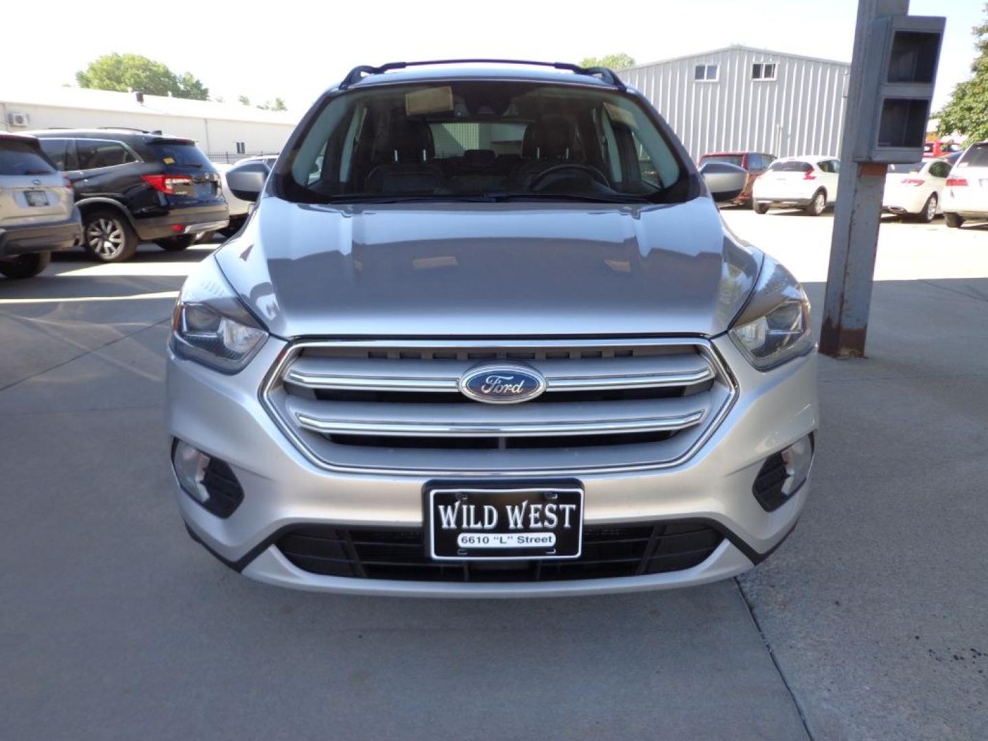 2018 SILVER FORD ESCAPE SEL (1FMCU9HD2JU) with an 1.5L engine, Automatic transmission, located at 6610 L St., Omaha, NE, 68117, (402) 731-7800, 41.212872, -96.014702 - THIS VEHICLE HAS A BEEN FULLY INSPECTED AND HAS A CLEAN TITLE WITH A FREE CARFAX REPORT PROVIDED! SHARP SEL WITH A CLEAN CARFAX, LOADED WITH PANORAMIC ROOF, NAV, FORD SAFE AND SMART PACKAGE INCLUDING, LANE KEEPING SYSTEM ,ADAPT CRUISE/COLLISION WARNING AND BLIS (BLIND SPOT INFO SYSTEM). ****- Photo#1
